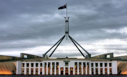 Parliament house in Canberra under a gloomy sky. Adobe.